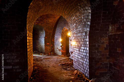 Dungeon under the old german fortress illuminated by lantern and candles © Mulderphoto