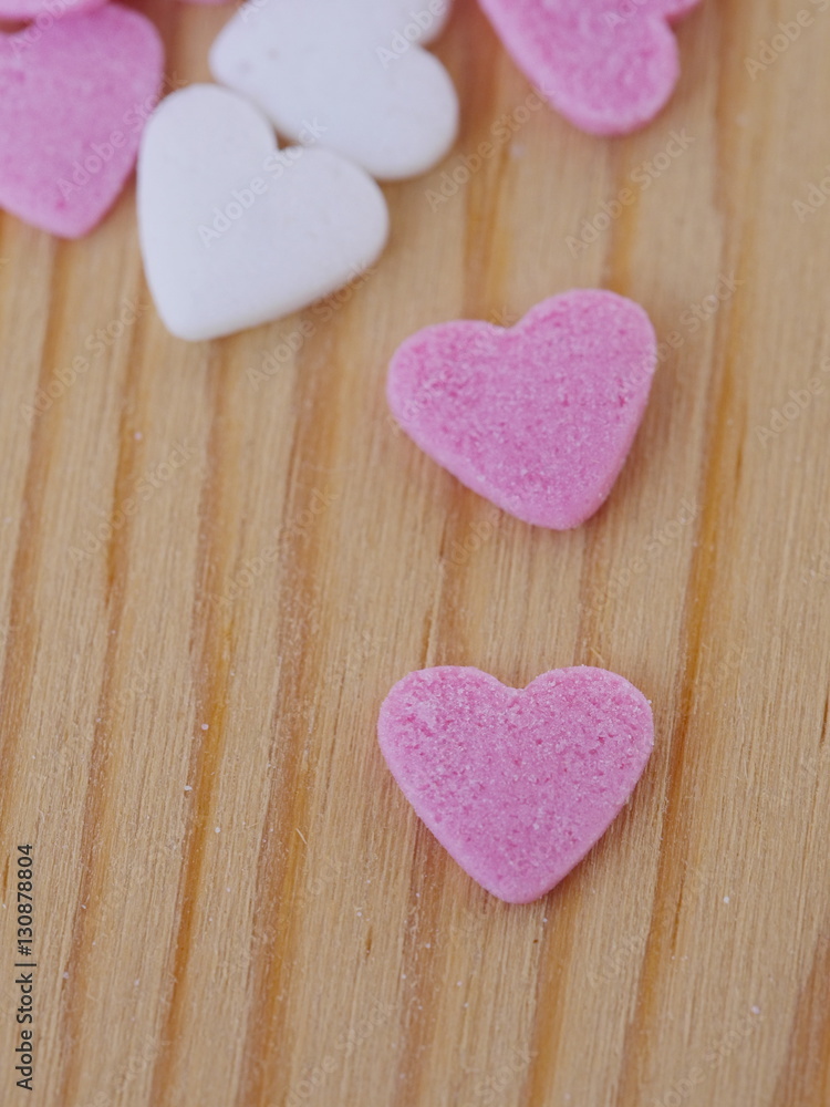 Obraz premium candy hearts wood background
