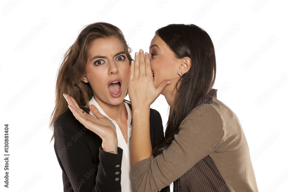 young gossip girl whisper to her friend's ear young gossip girl whisper to her friend's ear