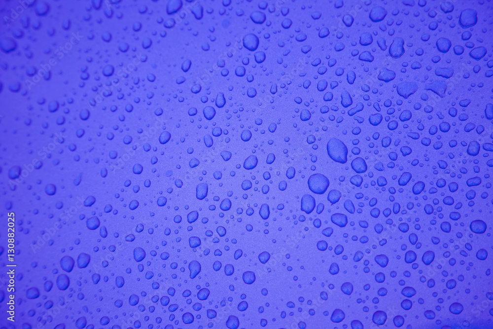 Rain drops on blue metal surface. Background and textures.