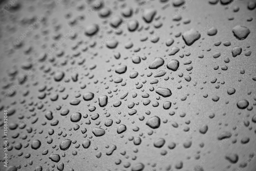 Rain drops on black and white metal surface. Rain drops on black and white metal surface.
