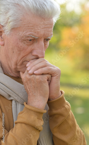 Sad elderly man outdoors