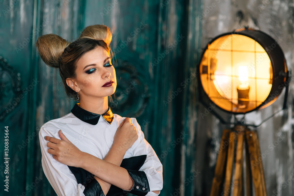 Naklejka premium Stylish young woman in black pants, white shirt. portrait of a business lady.