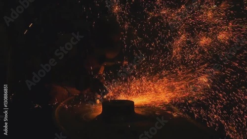 Welder arc Gouging carbon electrode rods   with sparks and smoke in manufacturing;