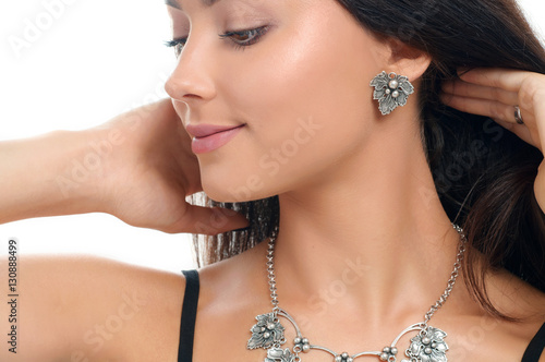 Studio portrait pretty young woman with collection stylish jewel