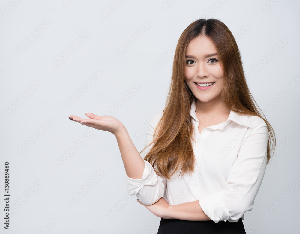 Attractive young beautiful Asian student woman showing empty copy space on her open hand palm Attractive young beautiful Asian student woman showing empty copy space on her open hand palm