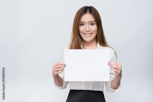 Attractive young beautiful Asian student woman holding blank white paper