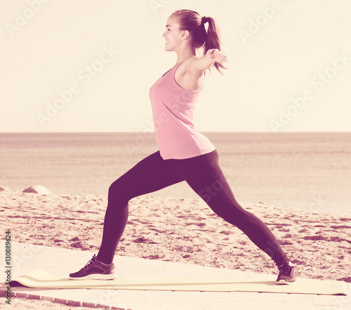 attractive girl exercising on exercise mat outdoor