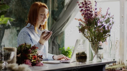 florist typing working with laptop phone and notes