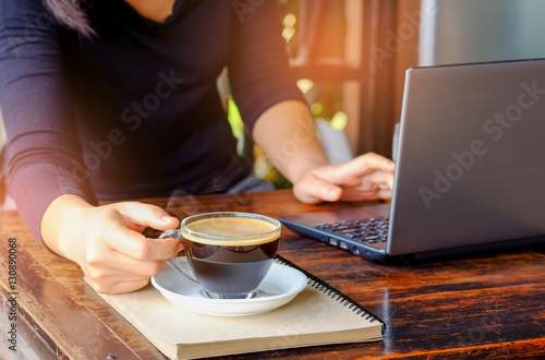 Business people working laptop with coffee on table.