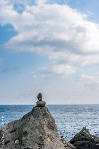 Landscape, sea in Ulleungdo Island South Korea, pyramid of stones on coast.