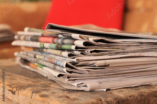 Newspapers on wooden table