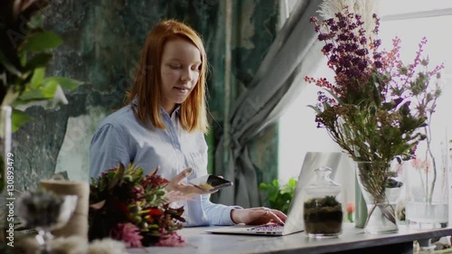 florist typing working with laptop and phone
