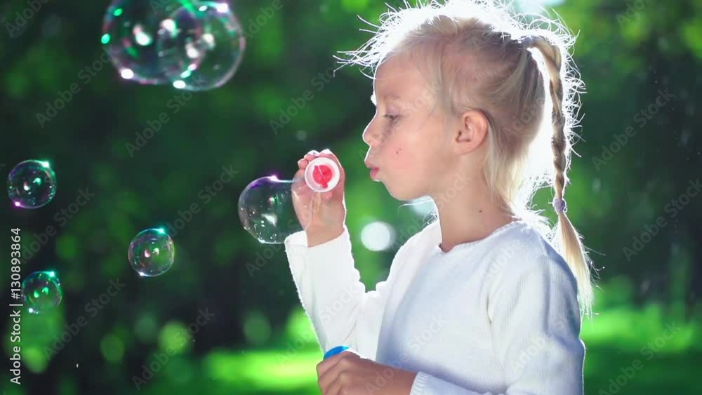 Little girl with soap bubbles in summer Little girl with soap bubbles in summer