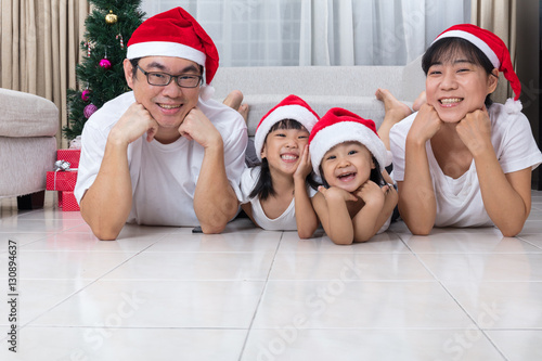 Happy Asian Chinese family lying on the floor celebrating Christ