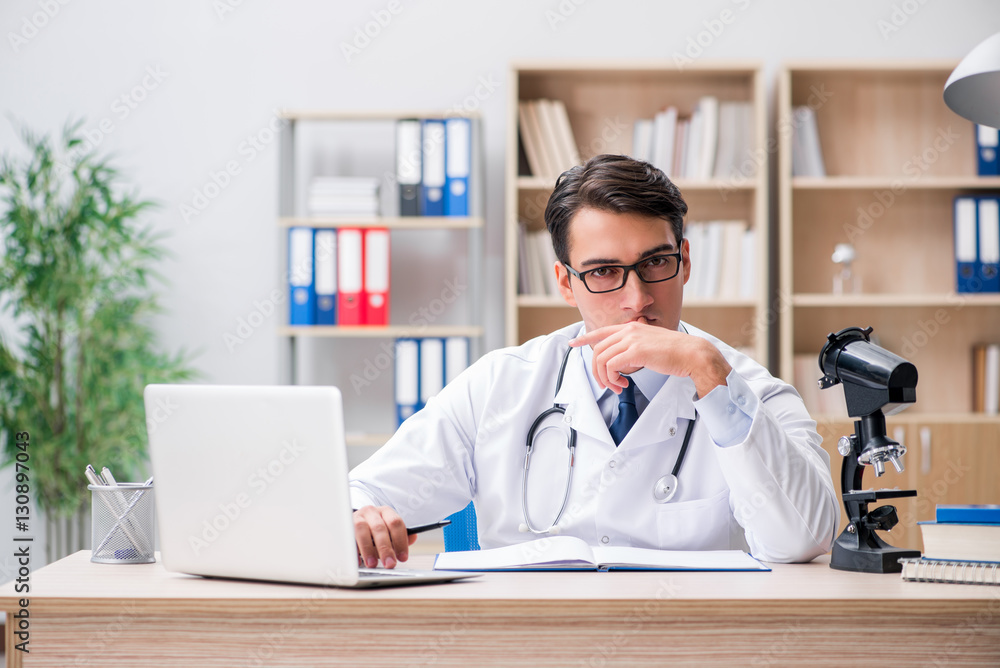 Young adult doctor with laptop computer Young adult doctor with laptop computer