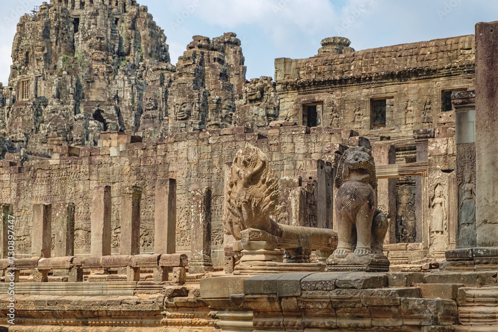 Naga cobra king Vasuki and Lion in the foreground guards Prasat Bayon, central temple of Angkor Thom, Siem Reap, Cambodia. Ancient Khmer architecture and famous Cambodian landmark, World Heritage.