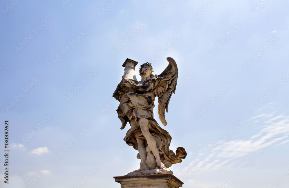 View of winged man statue with clear blue sky background at St. Angelo bridge in Rome. It was built in 134 A.D., with travertine marble fascias & spanning the River Tiber. View of winged man statue with clear blue sky background at St. Angelo bridge in Rome. It was built in 134 A.D., with travertine marble fascias & spanning the River Tiber.