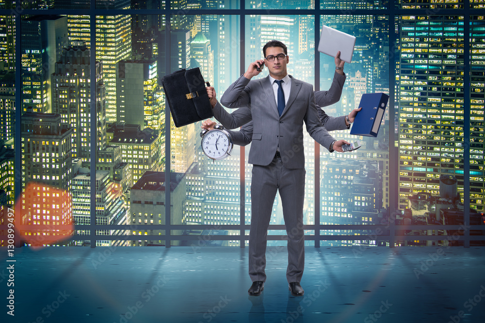 Fototapeta premium Young businessman in multitasking concept