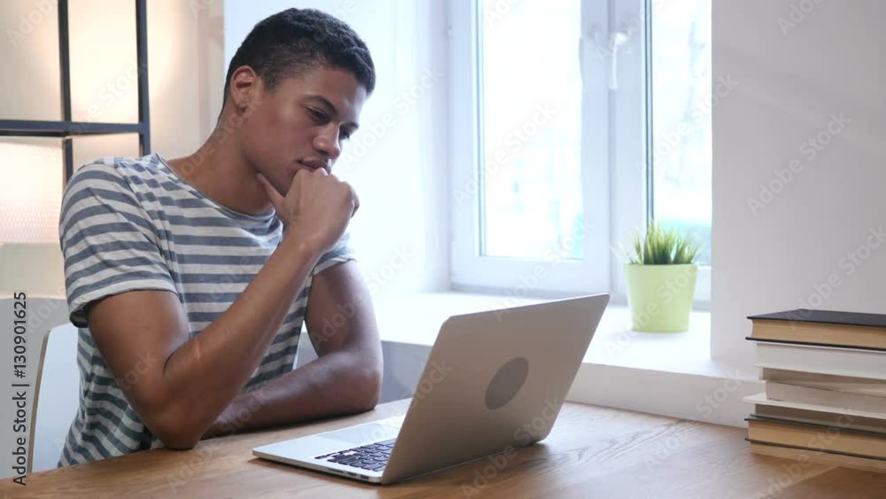 Black Man Thinking and Working on Laptop Black Man Thinking and Working on Laptop