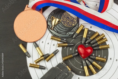 Shooting competition. Award winners. Biathlon victory. Ammunition and winners medals in biathlon. Diploma of shooting competitions. Background diploma.
 photo