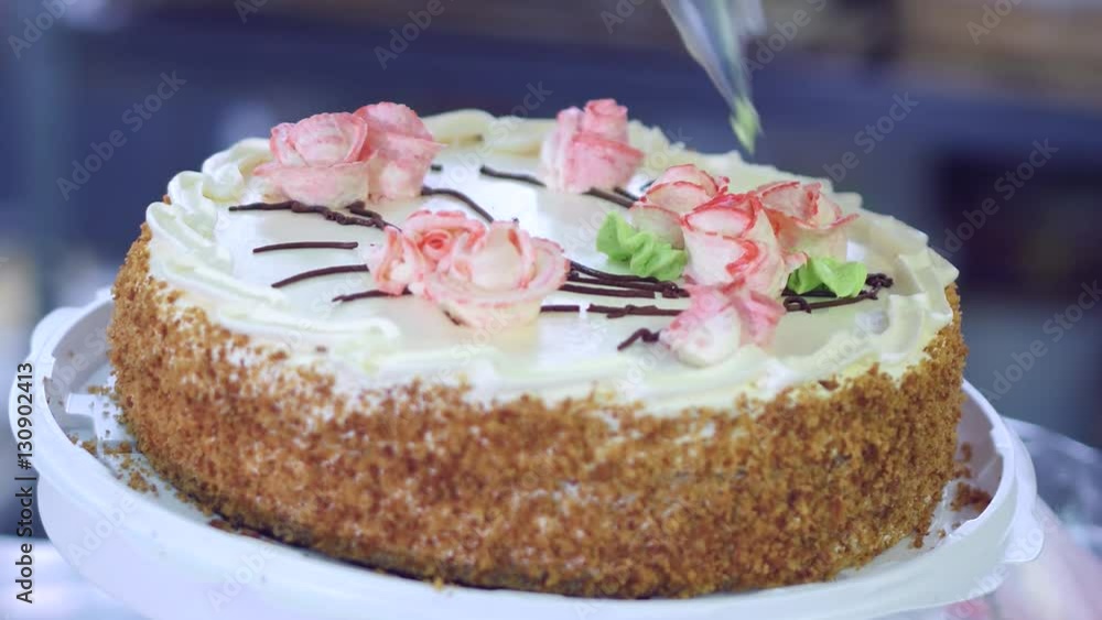 Confectioners hands decorating cakes. Cake production process. Confectioners hands decorating cakes. Cake production process.