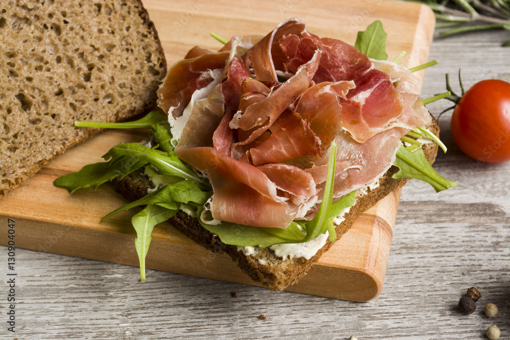 Sandwich with ham and vegetables, black bread Sandwich with ham and vegetables, black bread