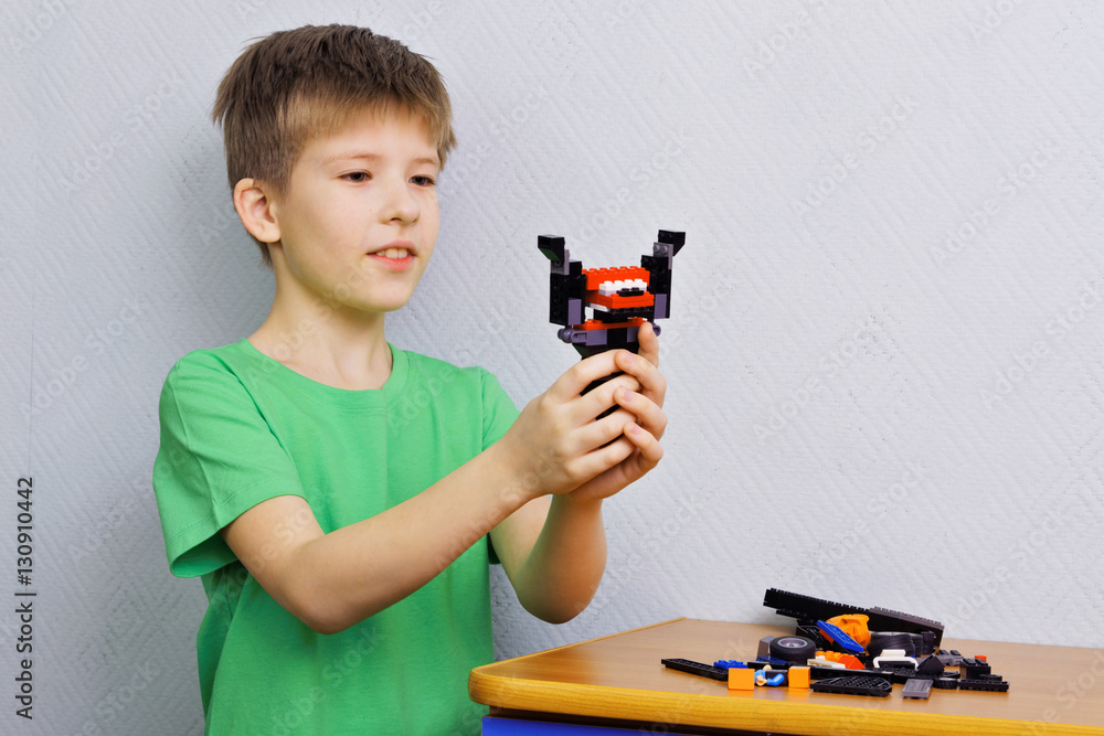 Boy with a toy of plastic parts