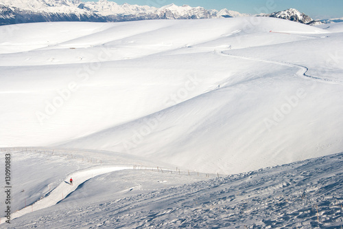 Cross country skier in a snowy mountain panorama © Alessandro