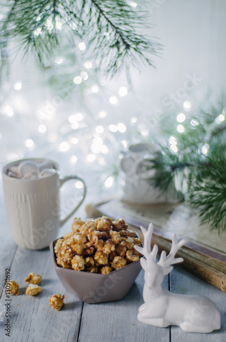 Popcorn on a winter background with Christmas tree