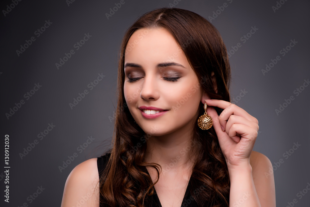 Young woman showing her new earrings Young woman showing her new earrings