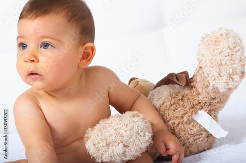 Baby with blue eyes smiling on white background photo