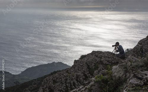 PENINHA, SERRA DE SINTRA, PORTUGAL - OCTOBER 18, 2014: The photographer is tacking pictures of the landscape from the highest viewpoint of Sintra region
