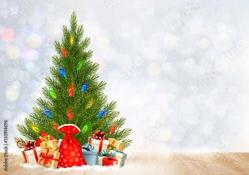 Holiday Christmas background with gift boxes and Christmas tree.