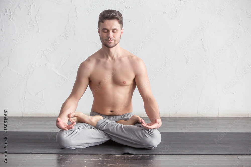 A man doing yoga exercises A man doing yoga exercises