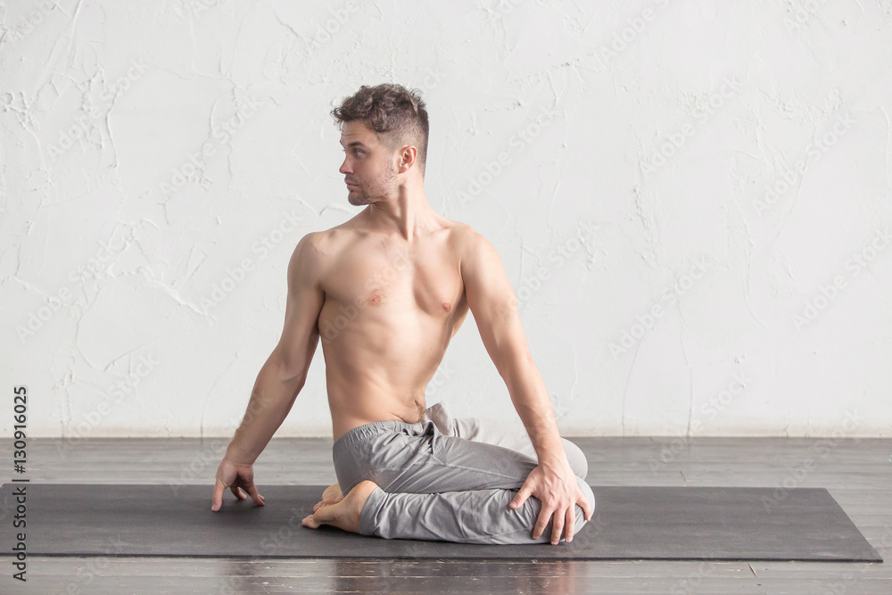 Naklejka premium A man doing yoga exercises