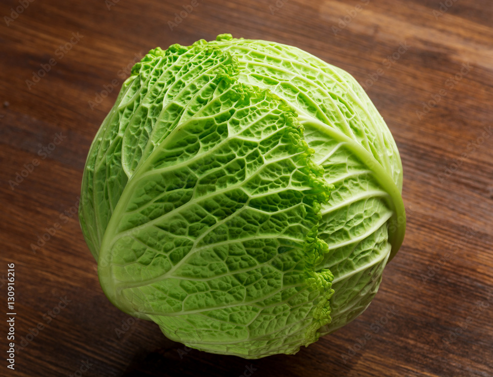 Fototapeta premium Fresh harvested cabbage, on a old grungy table. Vegetables with artistic impression