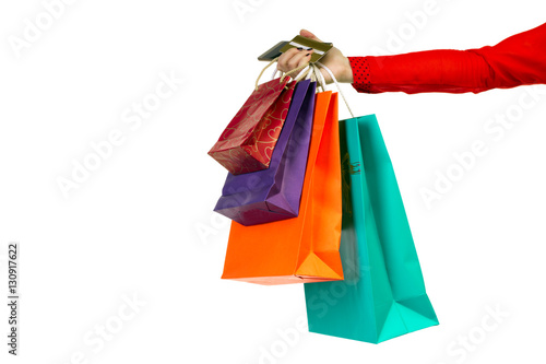 Woman hand holding colourful shopping paper bags, banking credit