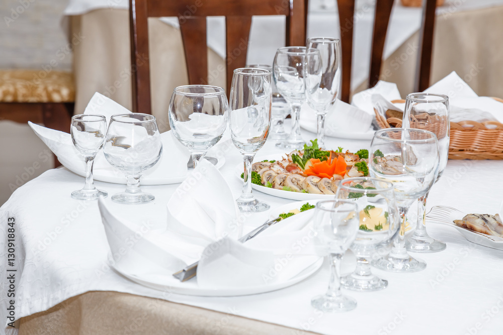 Cutlery and cold cuts served on a festive table in restaurant Cutlery and cold cuts served on a festive table in restaurant