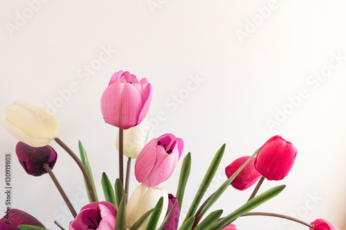 Fototapeta Naklejka Na Ścianę i Meble -  Assorted plastic artificial tulip flowers that are fake in pink