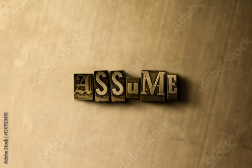 ASSUME - close-up of grungy vintage typeset word on metal backdrop. Royalty free stock - 3D rendered stock image.  Can be used for online banner ads and direct mail.