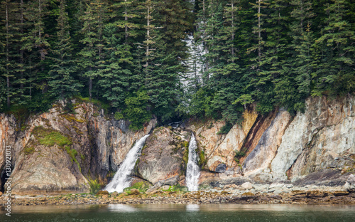 Small waterfall on the coast of Alaska. Alaska. USA. An excellent illustration.