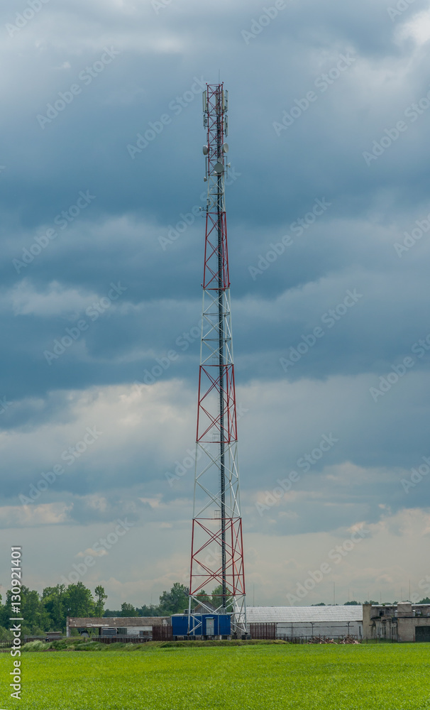 tower of mobile communication and telecommunication in rural areas against the background of the cloudy sky tower of mobile communication and telecommunication in rural areas against the background of the cloudy sky