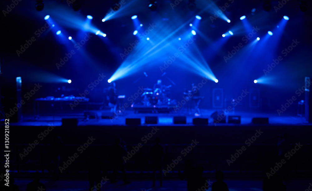 Perfect blurred background with blue concert lights, big stage. Electronic music concept.