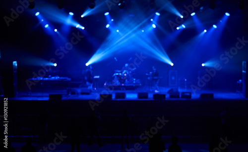 Perfect blurred background with blue concert lights, big stage. Electronic music concept. © Anatoliy Karlyuk