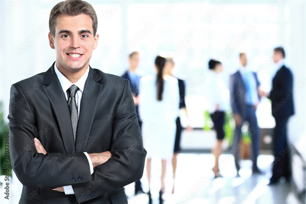 Happy mature business man looking at camera with satisfaction at office Happy mature business man looking at camera with satisfaction at office