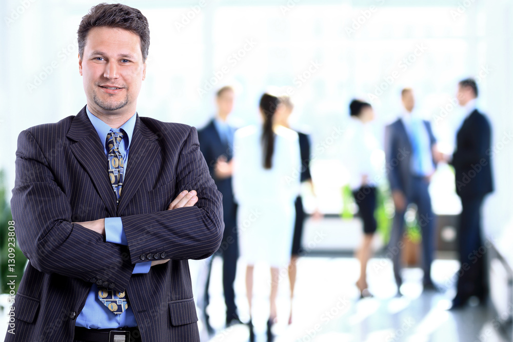 Happy mature business man looking at camera with satisfaction at office