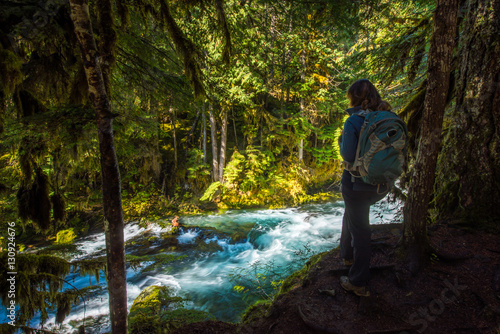 Tourist Backpacker looking at McKenzie River down from Sahalie F photo