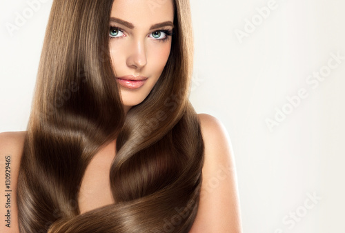 Obraz na plátně Brunette  girl with long  and   shiny wavy hair