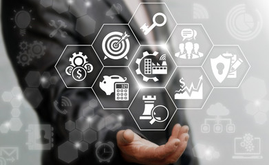 Industry 4.0 business concept. Businessman touched industrial modern gear factory icon on virtual screen on background of network manufacture sign. Manufacturing strategy computing future technology